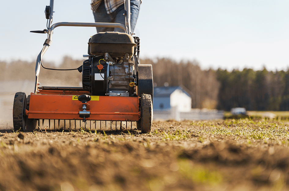 Lawn aerator and scarifier working on land