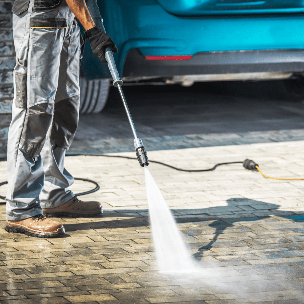 Man pressure washing driveway